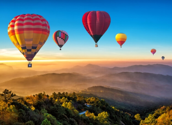 Balões coloridos de ar quente a sobrevoar a montanha em Dot Inthanon em Chiang Mai, Tailândia.